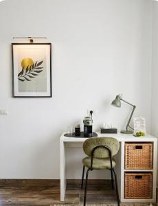 a white desk with a chair and a lamp at WelcHome Vitorchiano Guest House in Vitorchiano