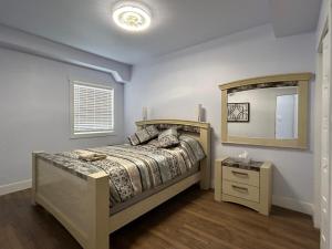 a bedroom with a bed and a large mirror at Cocagne Ocean Suites- Bed & Breakfast in Cocagne 