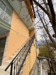 a building with a staircase in front of it at Kapo Apartments in Gjirokastër