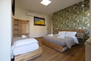 a bedroom with two beds and a wall with a mural at Costa d'Abruzzo - Casa Vacanza in Montesilvano