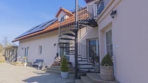 a building with a spiral staircase on the side of it at Apartmány U Petry in Luhačovice +10 photos