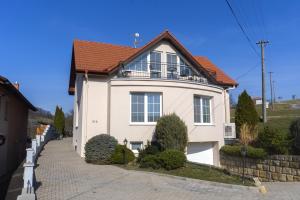 a white house with a red roof at Apartmány U Petry in Luhačovice