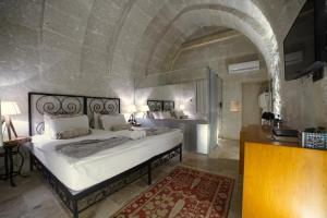 a bedroom with a large white bed in a room at The Loop Cappadocia in Avanos