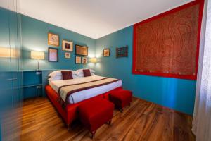 a bedroom with a bed and red chairs in it at Paruta Jazz Apartment in Venice