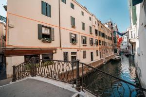 a view of a canal with buildings and a balcony at Paruta Jazz Apartment in Venice