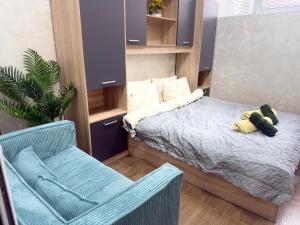 a small bedroom with a bed and a chair at Cozy Corner 41 in Ruse