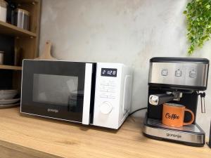 a microwave sitting on a counter next to a coffee maker at Cozy Corner 41 in Ruse +22 photos