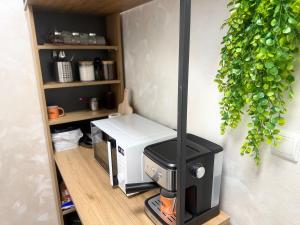 a small kitchen with a stove in a wall at Cozy Corner 41 in Ruse