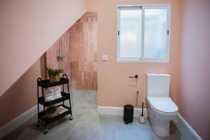 a bathroom with a toilet and a window at Casa Lombarda in Mérida +45 photos