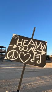a sign with the words have a new day at Heaven Dune Camp in Nuweiba +1 photo