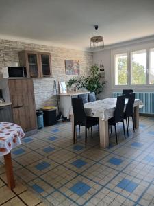 a kitchen with a table and chairs in a room at Les Cyclamens in Cosne-Cours-sur-Loire