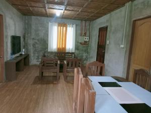 a dining room with a table and chairs and a window at Uya Mina Homestay in General Luna