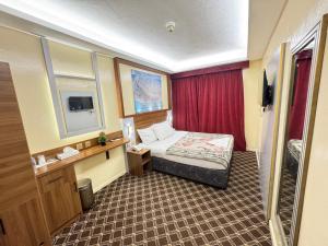 a hotel room with a bed and a red curtain at Naif Palace Hotel in Dubai +18 photos