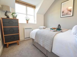 a bedroom with a bed and a dresser and a window at 2 Bed in York oc-81052 in Helmsley