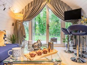 a living room with a blue couch and a glass table at 1 Bed in Consett oc-87933 in Shotley Bridge