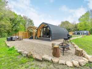 a small cabin with a fire pit in a yard at 1 Bed in Consett oc-87933 in Shotley Bridge