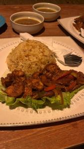 a plate of food with meat and rice on a table at Heaven Dune Camp in Nuweiba