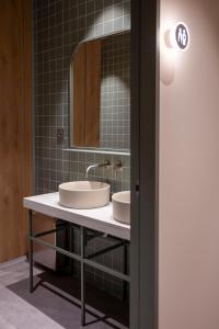a bathroom with two sinks and a mirror at The Central House Valencia Mercado Central in Valencia