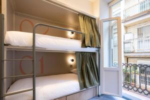 a bunk bed in a room with a window at The Central House Valencia Mercado Central in Valencia +56 photos