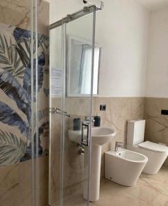 a bathroom with a shower and a sink and a toilet at Domu Bella in Decimomannu +13 photos