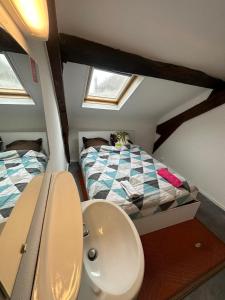 a bathroom with a sink and a bed in a room at Hôtel de la gare - Chambre standard in Tarbes