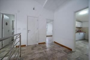an empty room with white walls and a staircase at Super Vila in Jajinci +23 photos