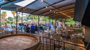 a patio at a restaurant with people sitting at tables at Camping Mas De Pierredon in Sanary-sur-Mer