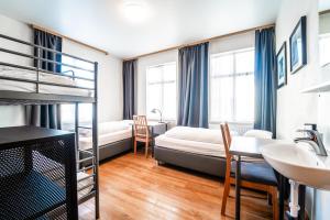 a bedroom with a bunk bed and a sink at Guesthouse Aurora in Reykjavík
