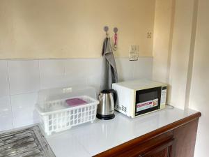 a kitchen counter with a microwave and a toaster at Yao noi cozy home in Ko Yao Noi +9 photos