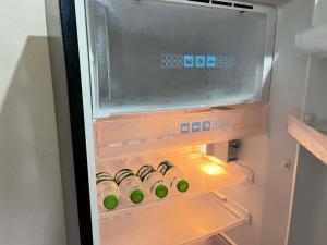 an open refrigerator with a bunch of bottles in it at Yao noi cozy home in Ko Yao Noi