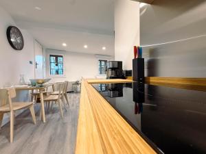 a kitchen with a black refrigerator and a table at Casa da Escola in Combarro