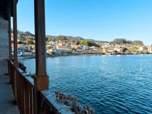 a view of a large body of water with houses at Casa da Escola in Combarro