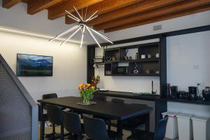 a dining room with a black table and chairs at Gio Leo Guest House in Lesa