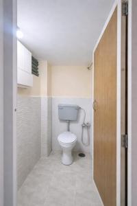 a bathroom with a white toilet in a room at Vishram Yatri Niwas in Kolhapur