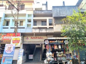 a building with a shop in front of it at Vishram Yatri Niwas in Kolhapur