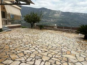 a stone patio with a view of a mountain at Reposo in Nikolítsion