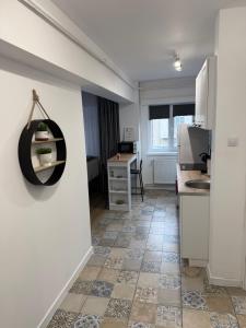 a room with a kitchen with a sink and a desk at Central Studio Yoko , Craiova in Craiova
