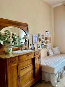 a bedroom with a dresser with a mirror and a bed at Villa Ada in Monsummano Terme