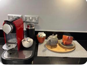 a kitchen counter with a red toaster and some cups at 2 Bedr Portmarnock Dublin Suburb in Dublin