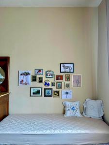 a bedroom with a bed with pictures on the wall at Villa Ada in Monsummano Terme