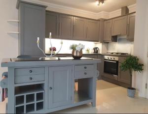 a kitchen with a white island in the middle at 2 Bedr Portmarnock Dublin Suburb in Dublin