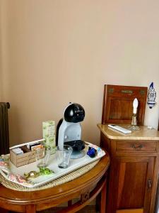 a table with a tea kettle and glasses on it at Villa Ada in Monsummano Terme