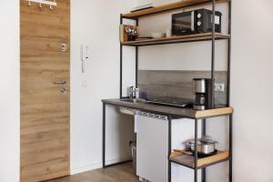 a kitchen with a counter and a microwave on a shelf at Monteurzimmer Oldenburg i.H. – Top Lage in Oldenburg in Holstein