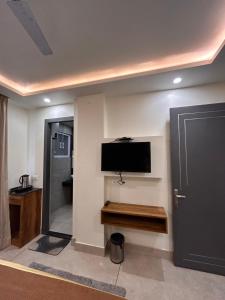 a living room with a flat screen tv on a wall at Garden view by Midtown in Katra +10 photos