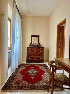 a room with a dresser and a red rug at Villa Ada in Monsummano Terme +73 photos