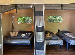 a room with two beds in a tent at Camping Le Soleil du Verdon in Esparron-de-Verdon