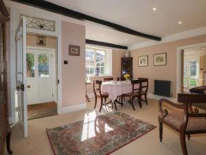 a living room with a dining room table and chairs at Rectory Cottage in Alton +9 photos