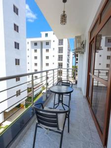 a balcony with two chairs and a table on it at Giannas stays 3B in Mombasa