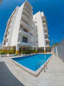 a building with a swimming pool in front of a building at Giannas stays 3B in Mombasa
