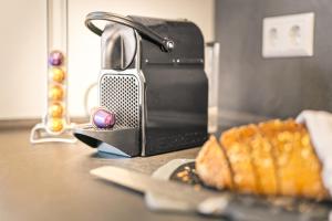 a toaster sitting on a counter next to a plate of food at Holiday&Stay, Tiny living in Fronreute
